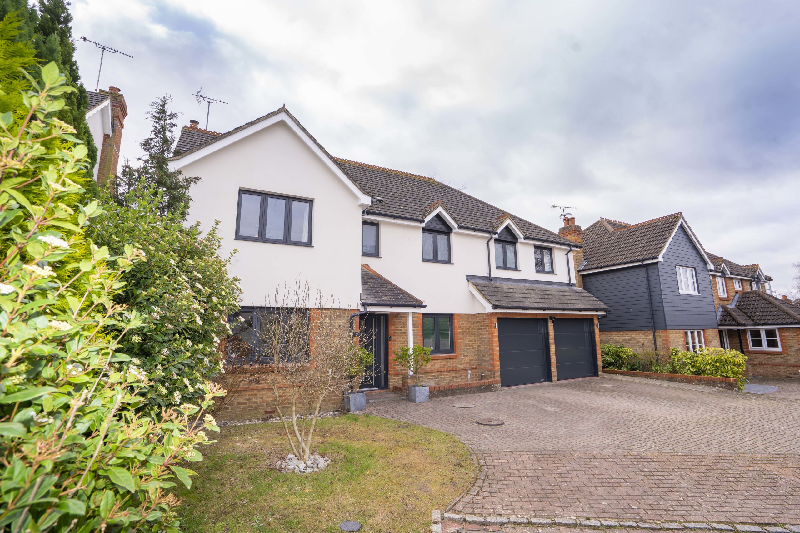 cream rendered house with grey windows